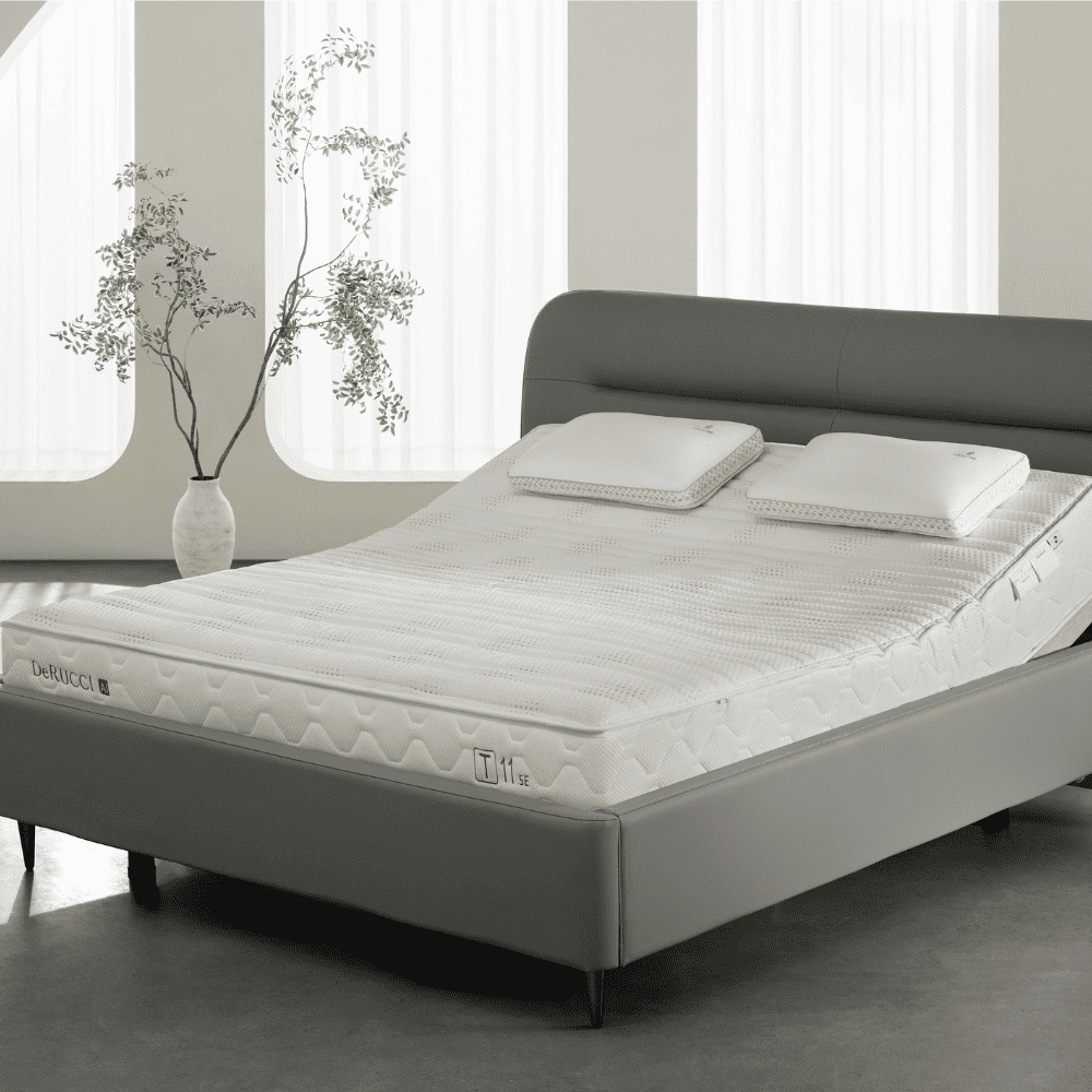 DeRUCCI T11 SE AI Smart Mattress resting on an adjustable bed base, showcasing independent dual-zone adjustment with one side elevated for customizable lifestyle comfort and support.