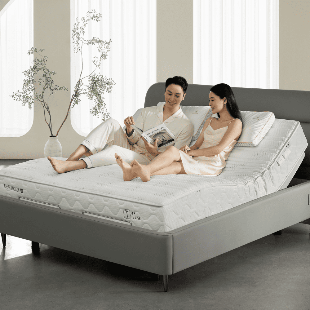 A couple lounging in reading mode on the derucci t11 se ai smart mattress, showcasing its seamless compatibility with motorized adjustable bed bases for personalized lifestyle comfort